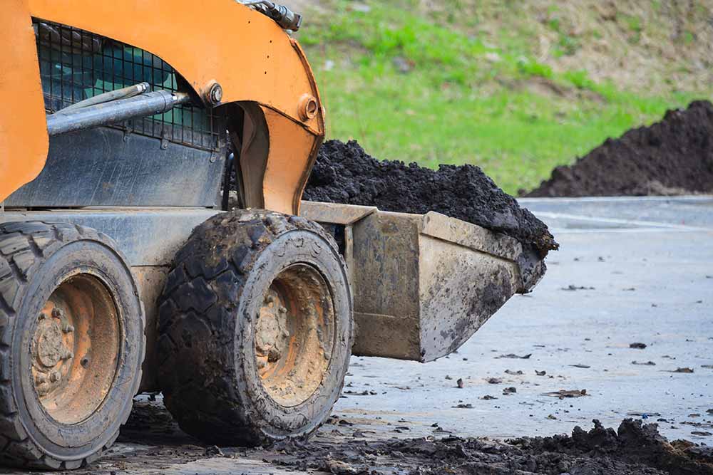 Skid Steer Transporting Soil